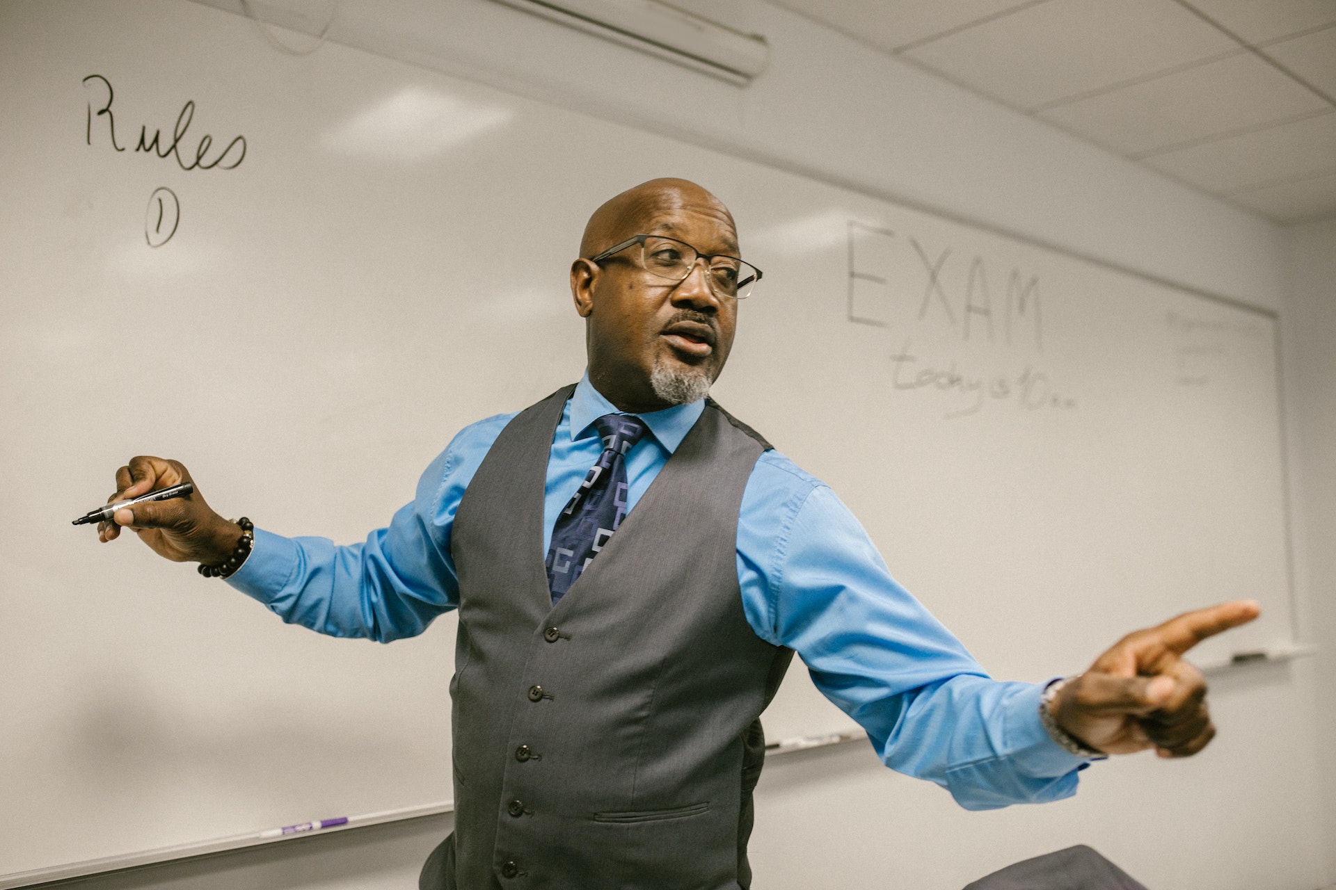 Photo by RDNE Stock project: https://www.pexels.com/photo/teacher-giving-out-instructions-not-to-cheat-7092613/
